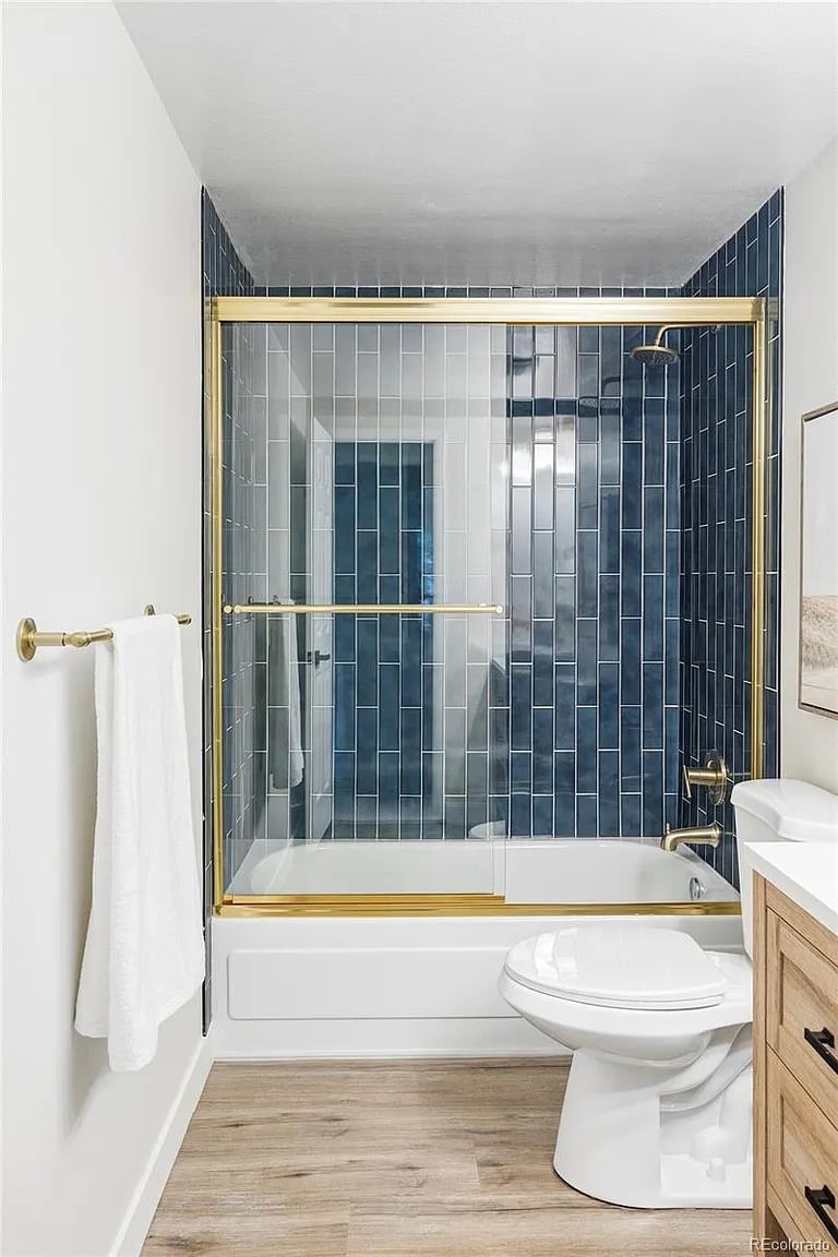 Modern cleaned bathroom with gold accents in Denver home by SparkEaseCleaning