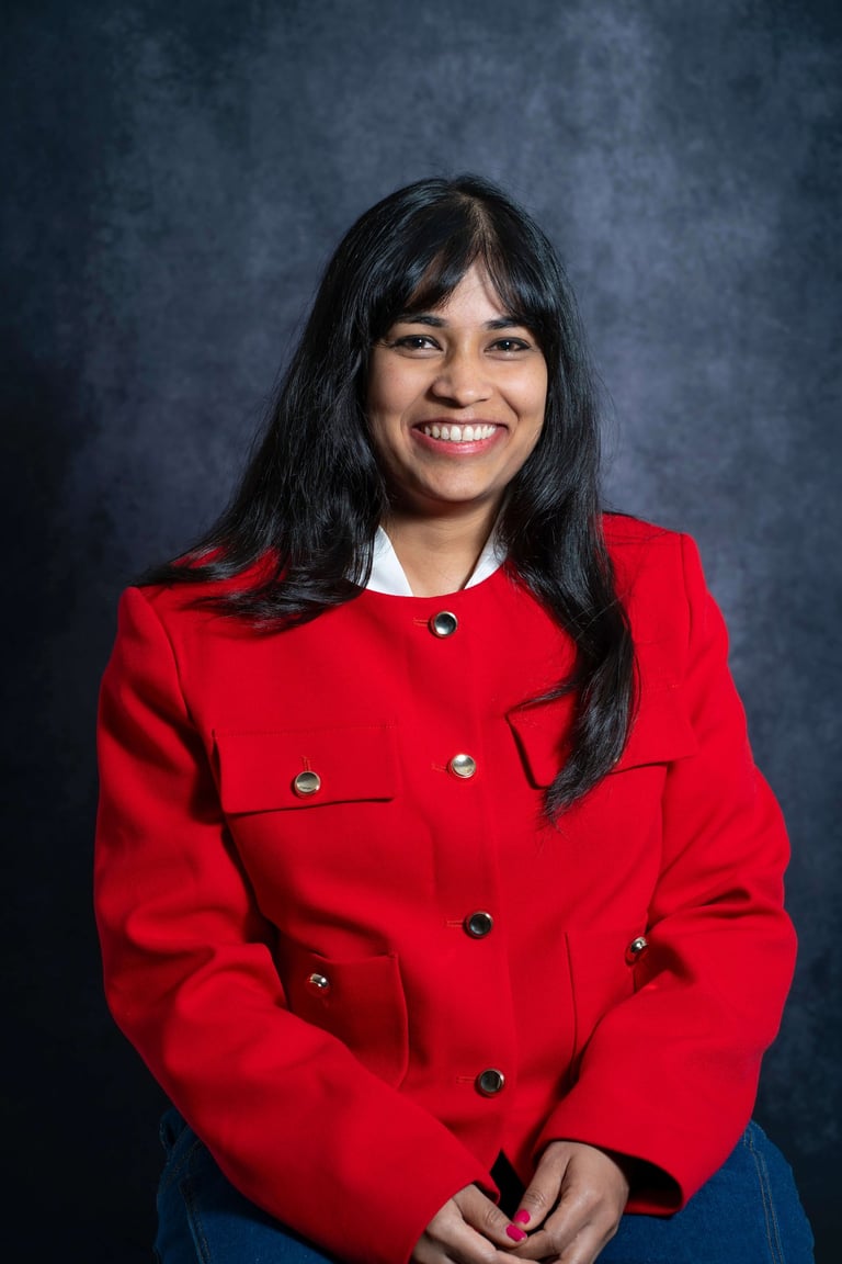 a woman in a red coat and jeans