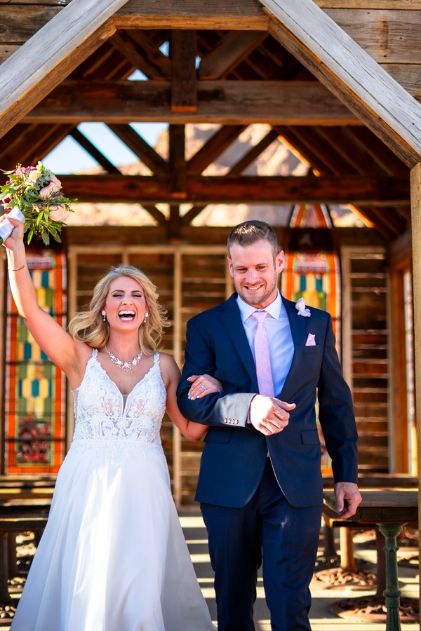 a bride and groom walking down the aisle of a wedding ceremony