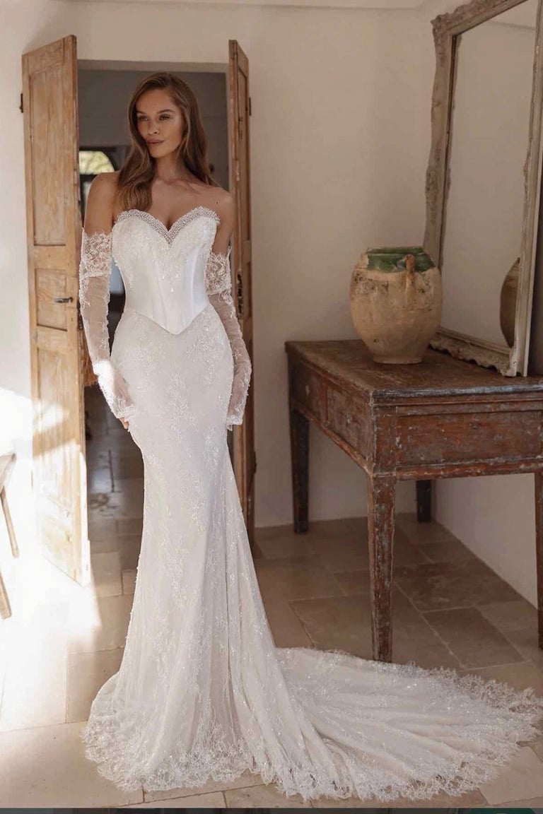 a woman in a white dress with a long sleeved dress