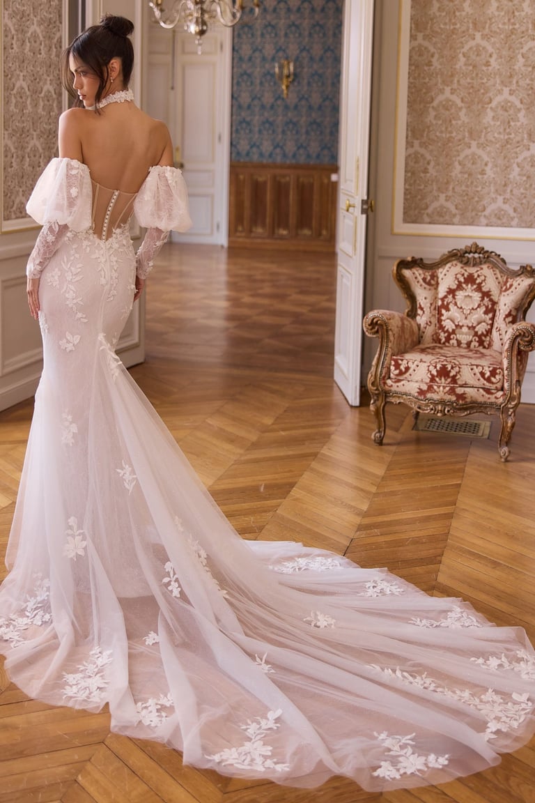 Elegant off-the-shoulder mermaid wedding dress with floral lace details and a long tulle train.
