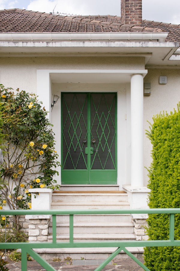 a green door with a green gate and a green gate