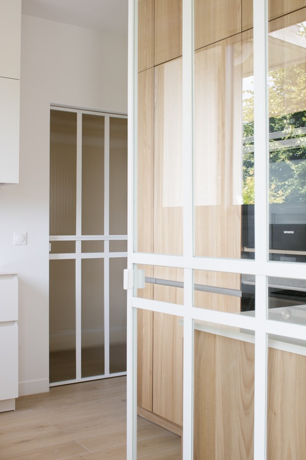 a kitchen with a wooden floor and a white cabinet