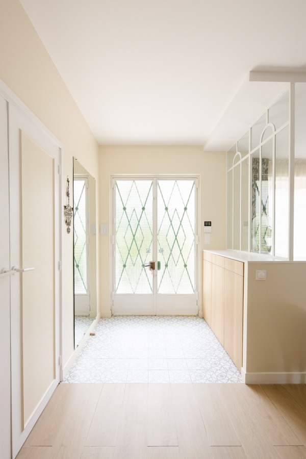 a hallway with a large window and a door
