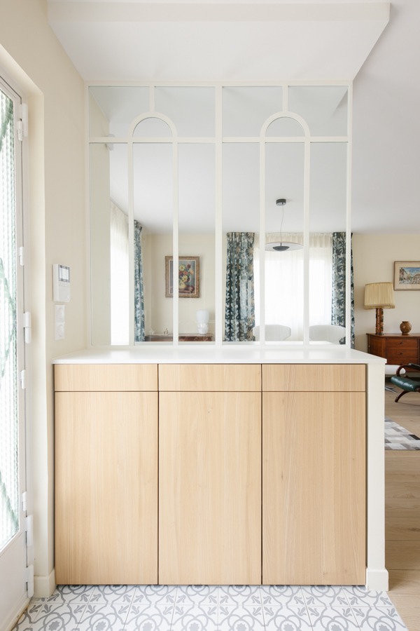 a kitchen with a large mirror and a sink