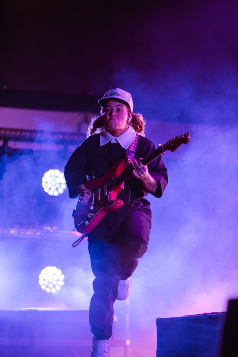 Tash Sultana rocks out on stage with their guitar at the Adelaide Vintage Vibes Festival