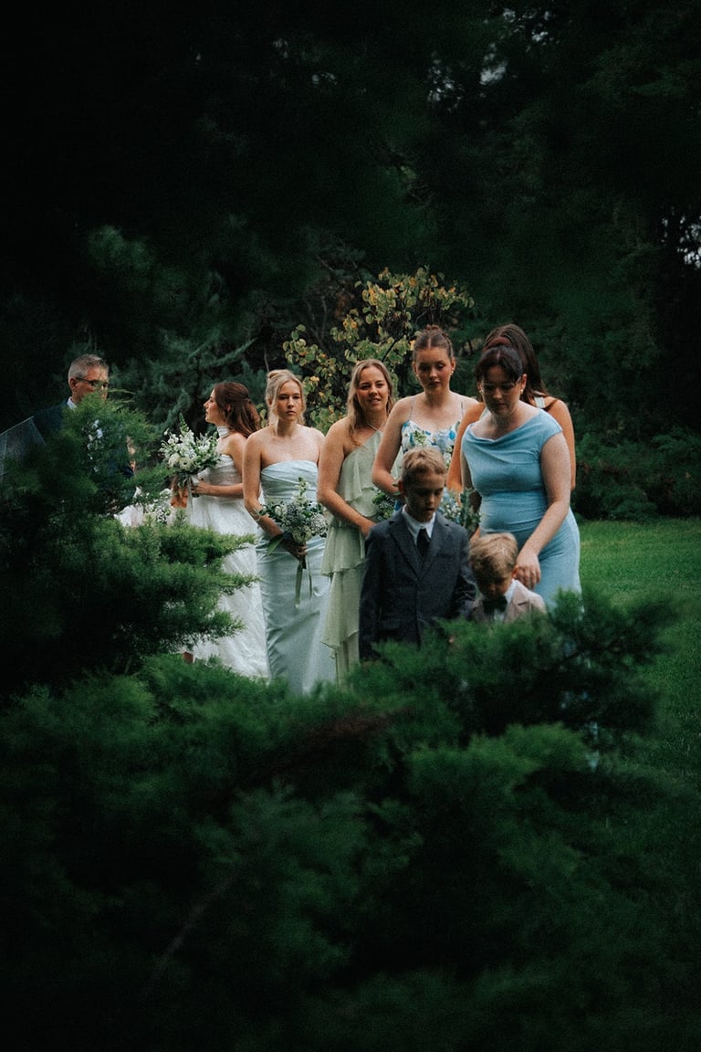 Wedding guests walking through Adelaide Botanic Garden before the ceremony