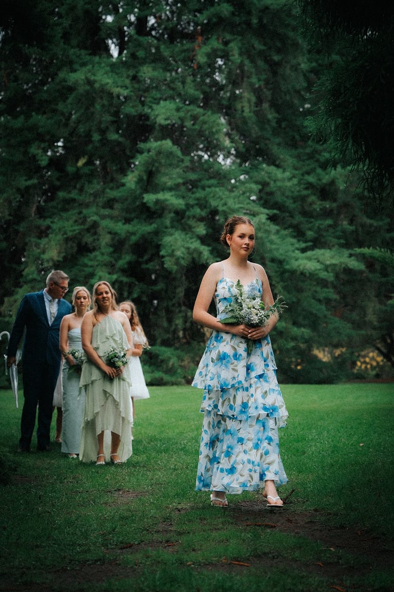 Bride walking down the aisle at Araucaria Avenue in Adelaide Botanic Garden