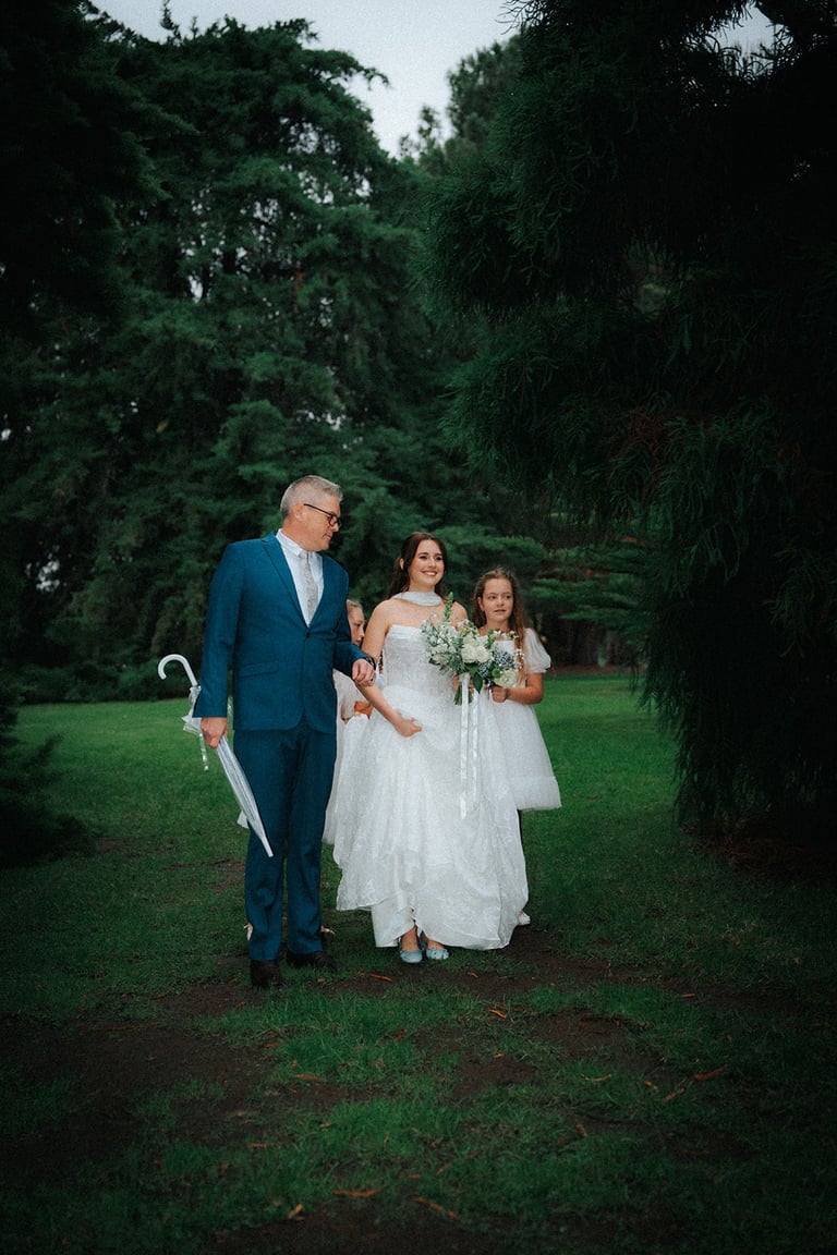 Bride walking with family before the outdoor wedding ceremony in Adelaide