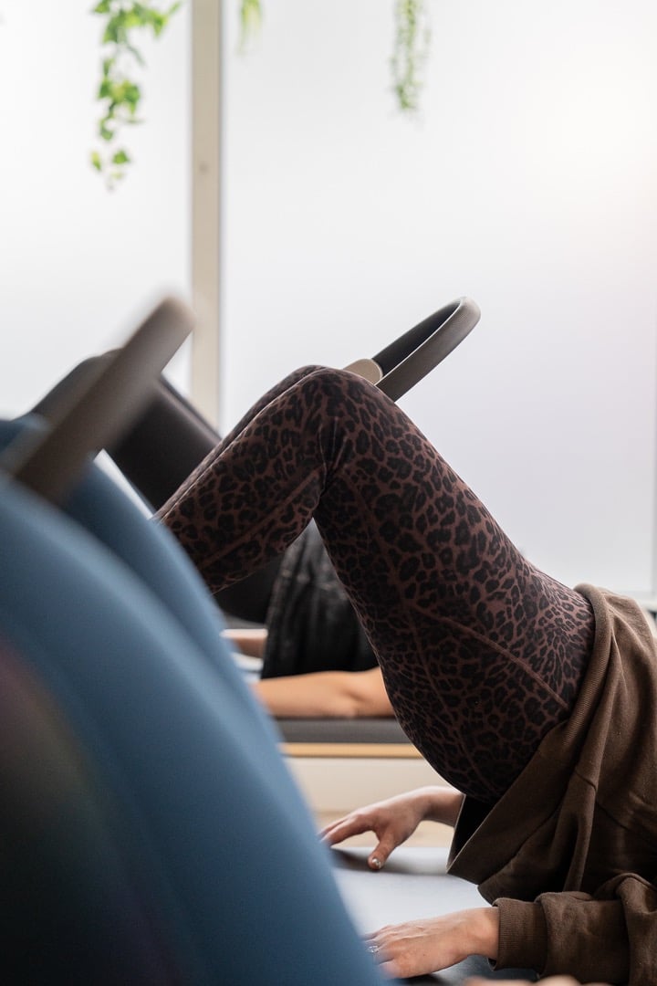 woman doing pilates with pilates ring between knees