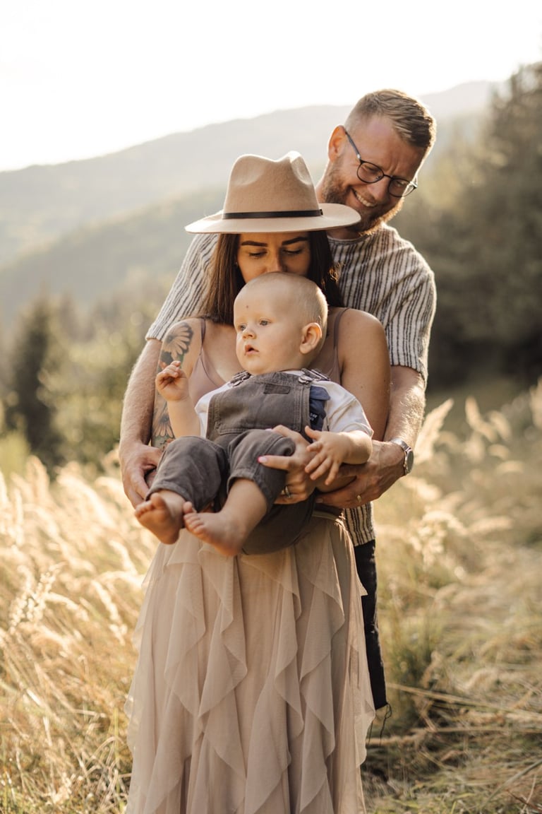 Mother and father holding their baby during an outdoor family photoshoot in the South Downs 