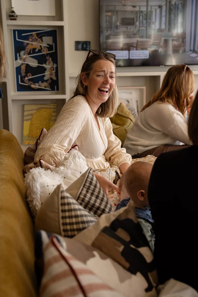 Woman sitting on the sofa and laughing 