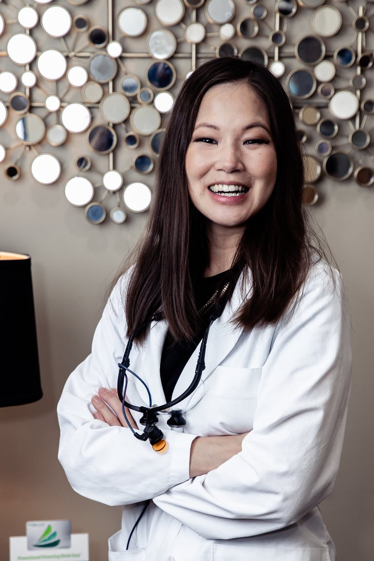 A picture of a smiling dentist, Dr. Oyama.