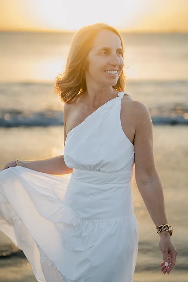 Mother smiling during a golden hour family photography session at Jimbaran Beach Bali
