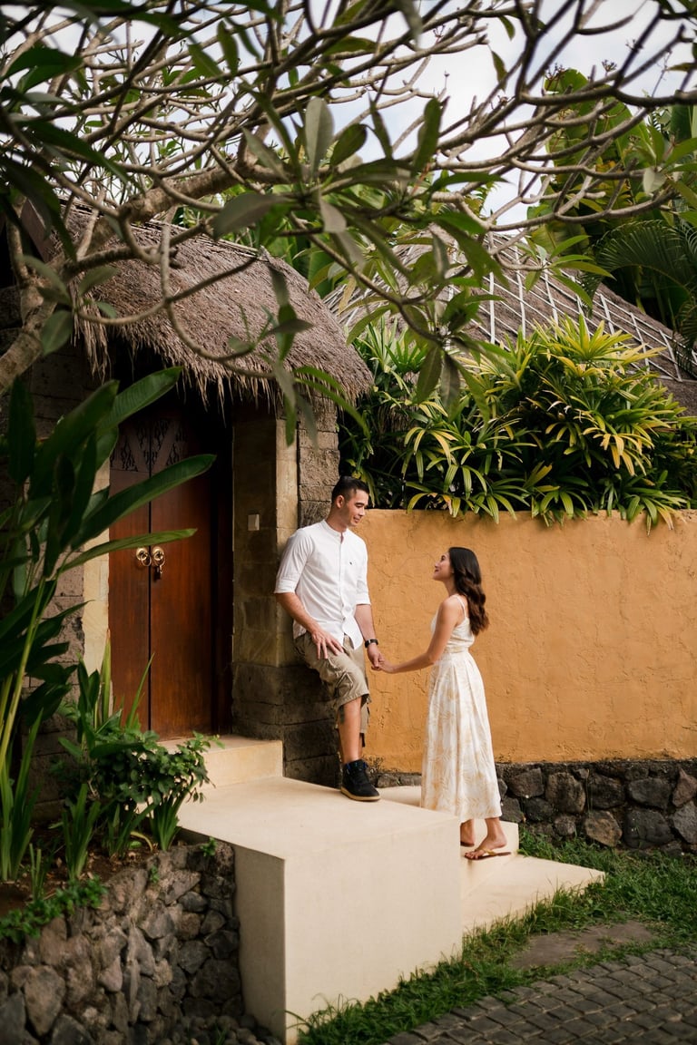 Couple standing at villa entrance surrounded by tropical greenery at Waka Gangga Tabanan