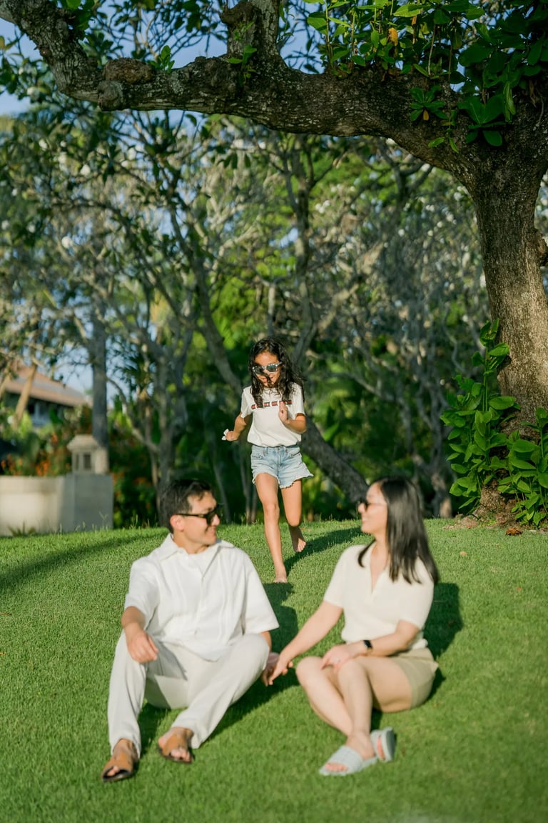 Child playing in the resort garden during a family photography session at InterContinental Bali Resort