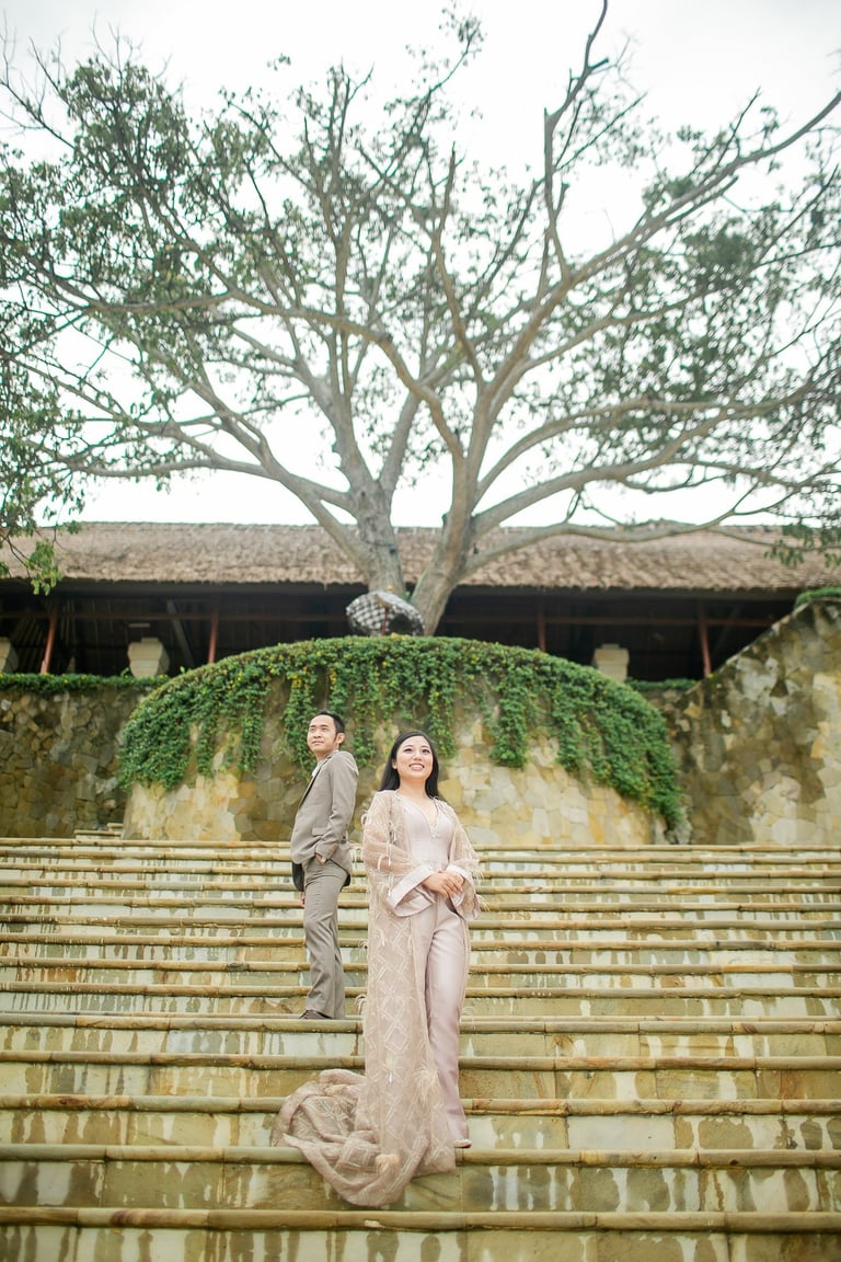 Elegant prewedding couple standing on grand staircase at Amankila Karangasem
