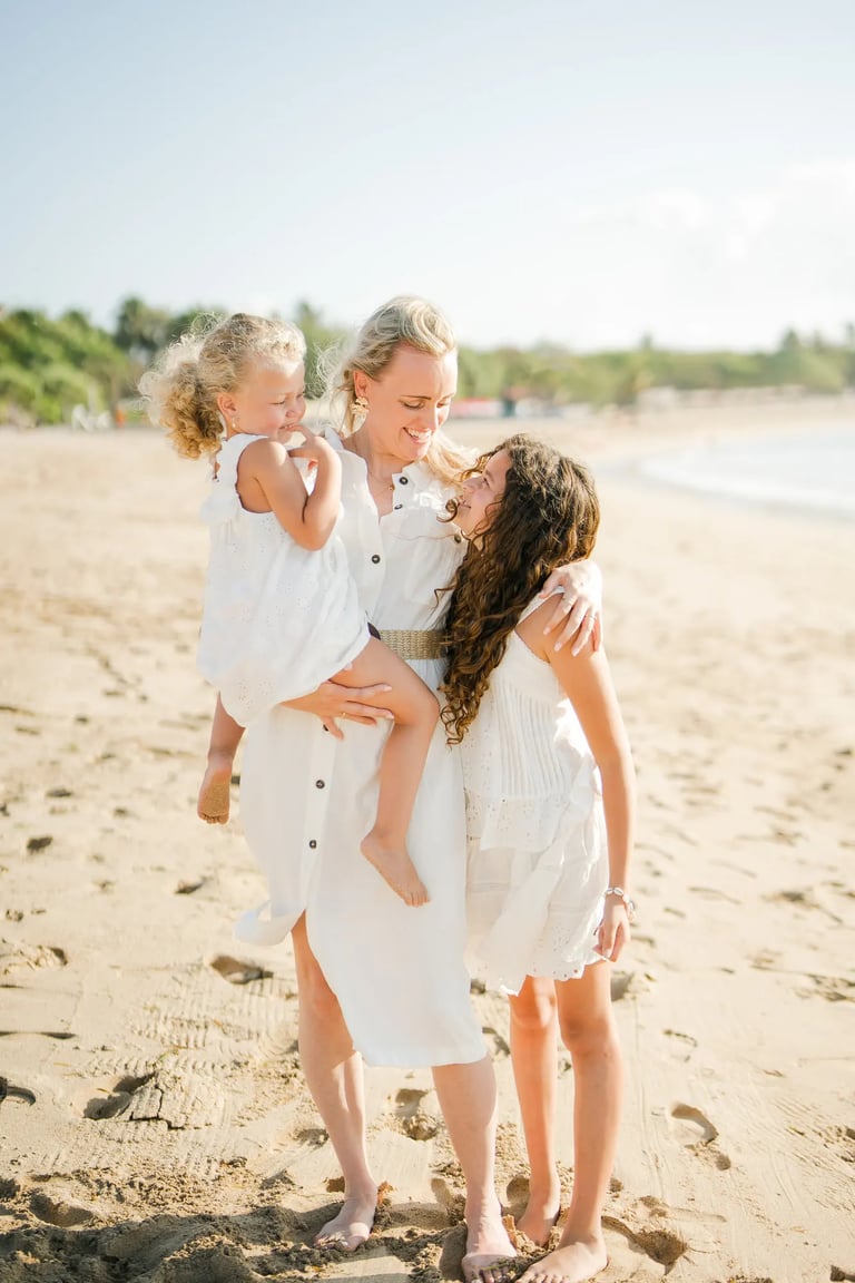 Mother and daughter sharing a joyful embrace during a family photography session at Ayodya Resort Bali