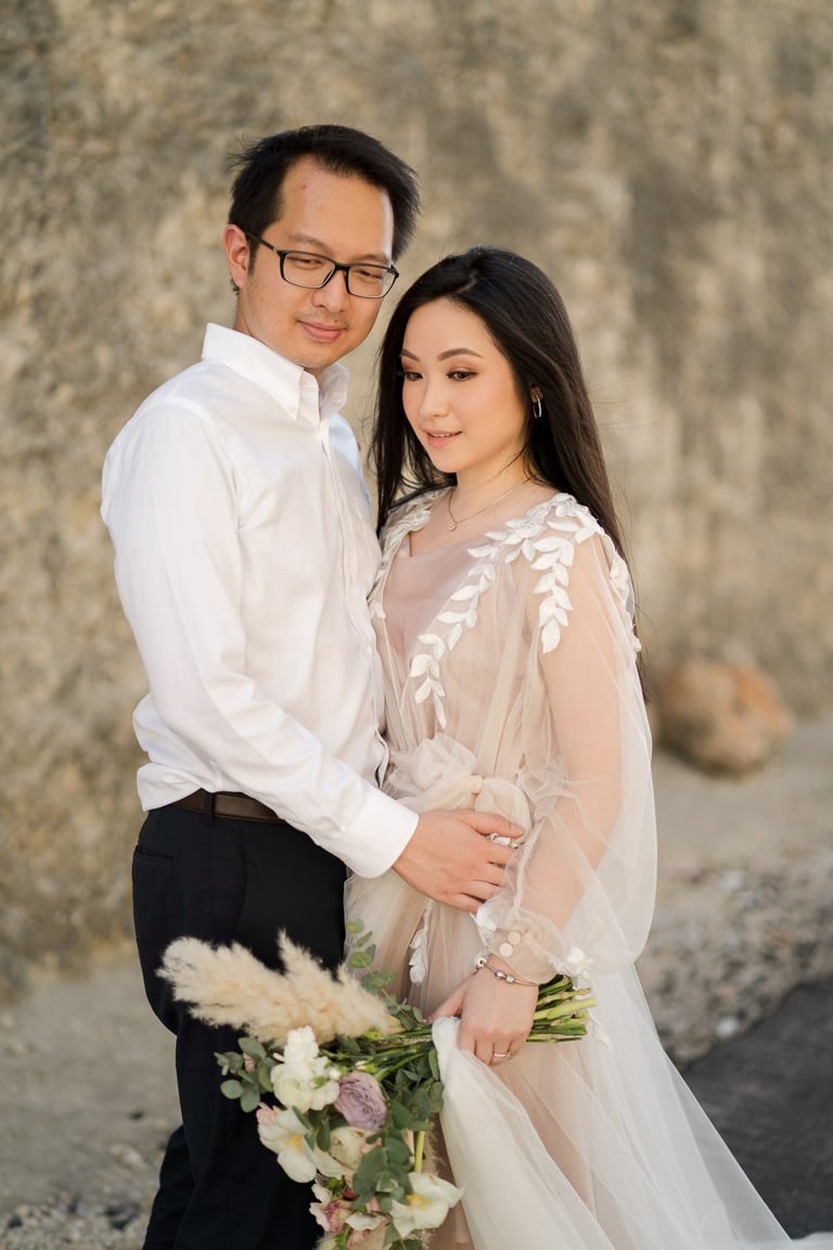 Luxury prewedding couple portrait by limestone cliff at Melasti Beach Ungasan Bali
