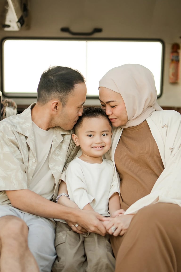 Tender family moment inside a retro combi van during Ilham family photography session at Melasti Beach Bali
