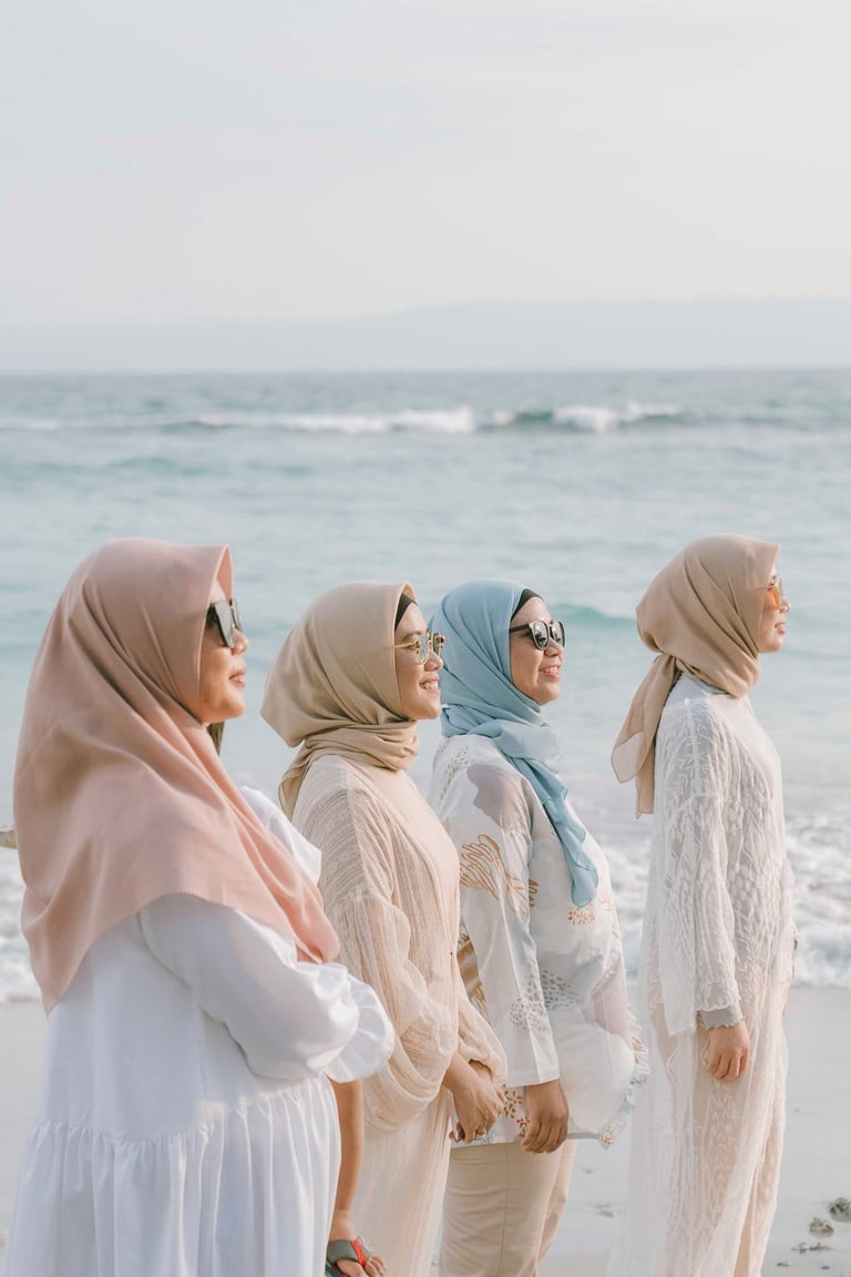Friends standing together by the ocean during photoshoot at Candi Beach Resort Karangasem Bali