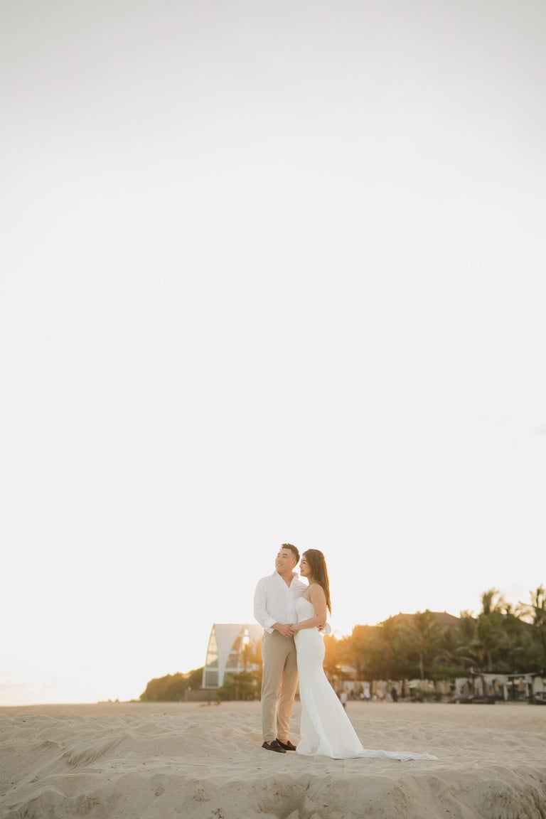 Couple standing together during sunset beach prewedding photoshoot at Apurva Kempinski Bali