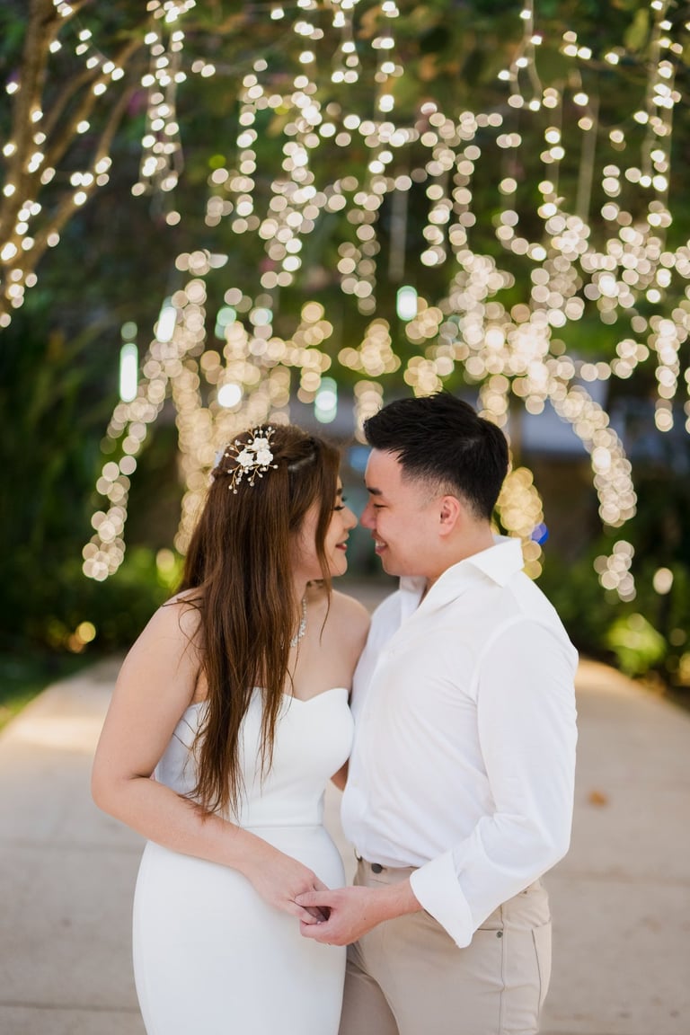 Romantic couple portrait under warm garden lights during a prewedding photoshoot at Apurva Kempinski Bali