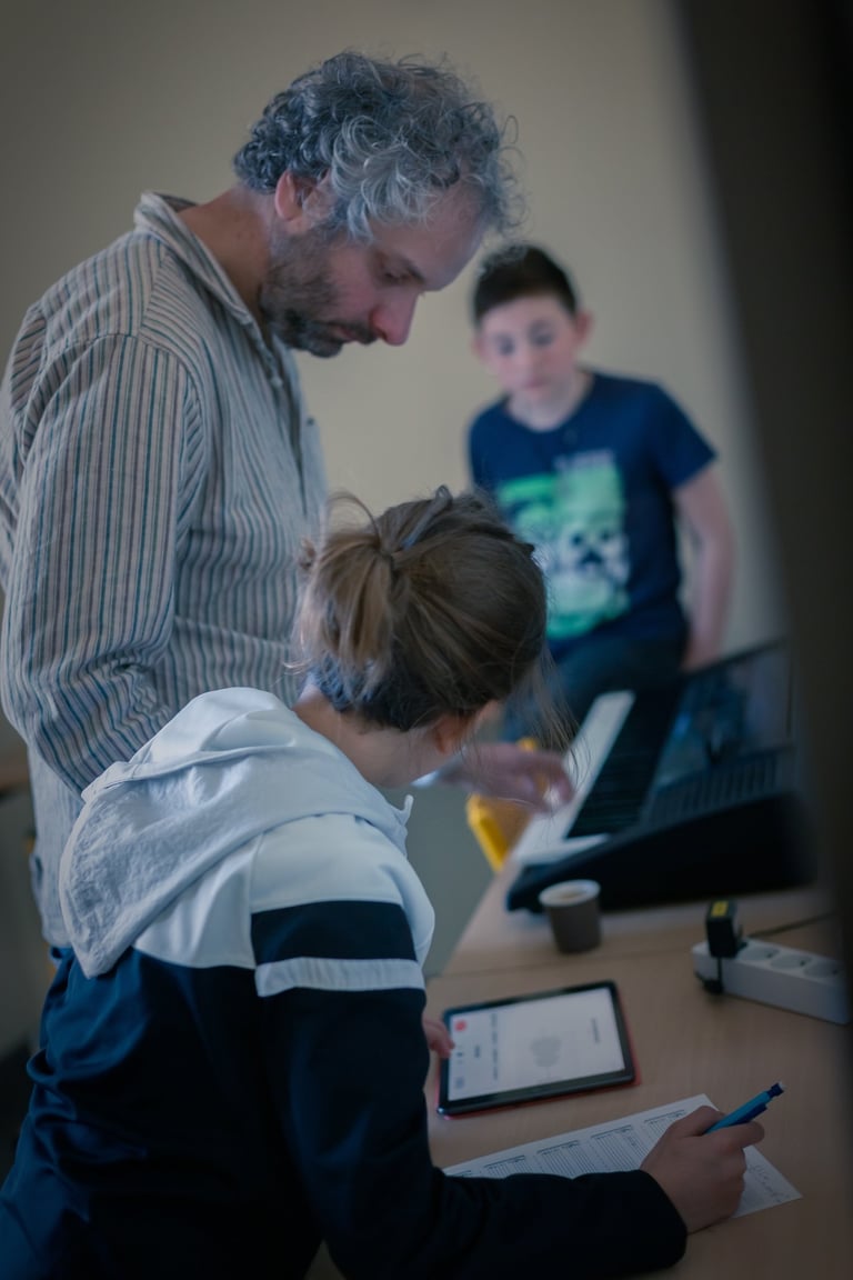 Dorian Chamoin and a student are looking at a tablet