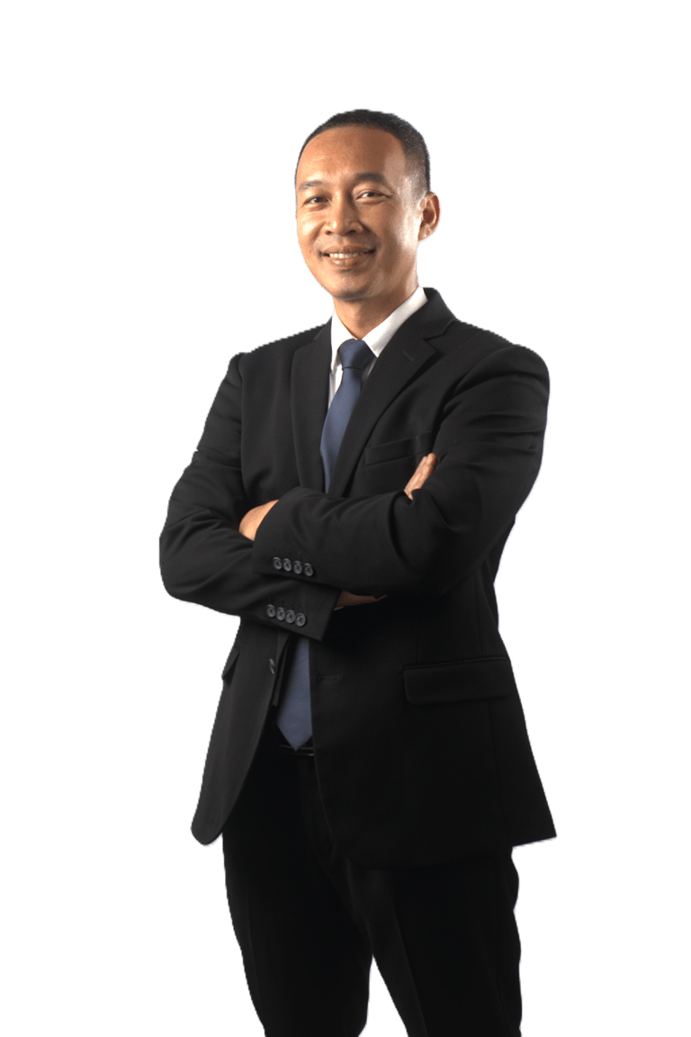 Smiling Asian businessman in a formal black suit and blue tie with arms crossed.