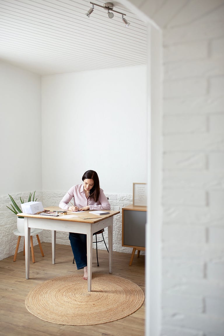 a woman sitting at a table with papers