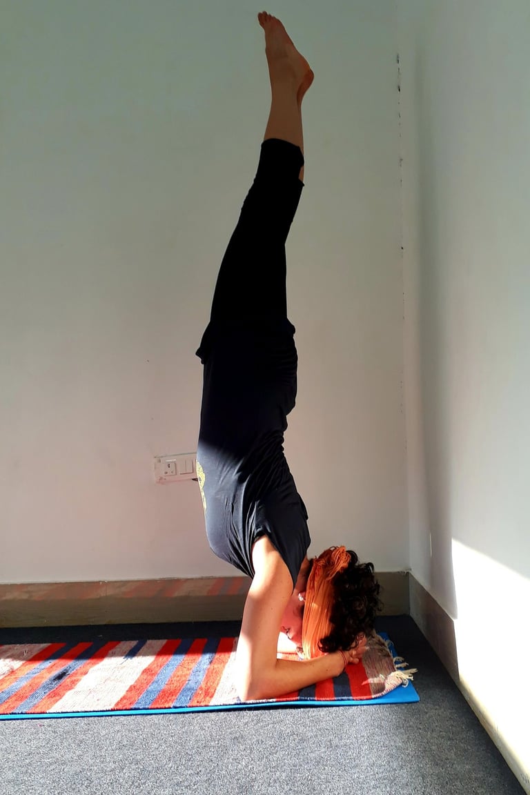 a woman doing a handstand yoga pose