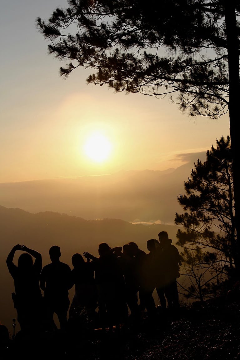 a group of people standing on a mountain top