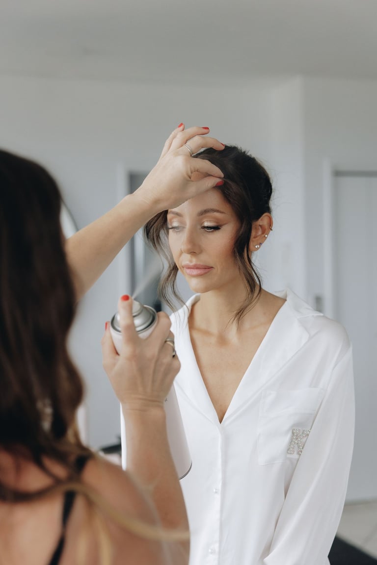 a woman is getting her hair styled by a professional hairdressucker