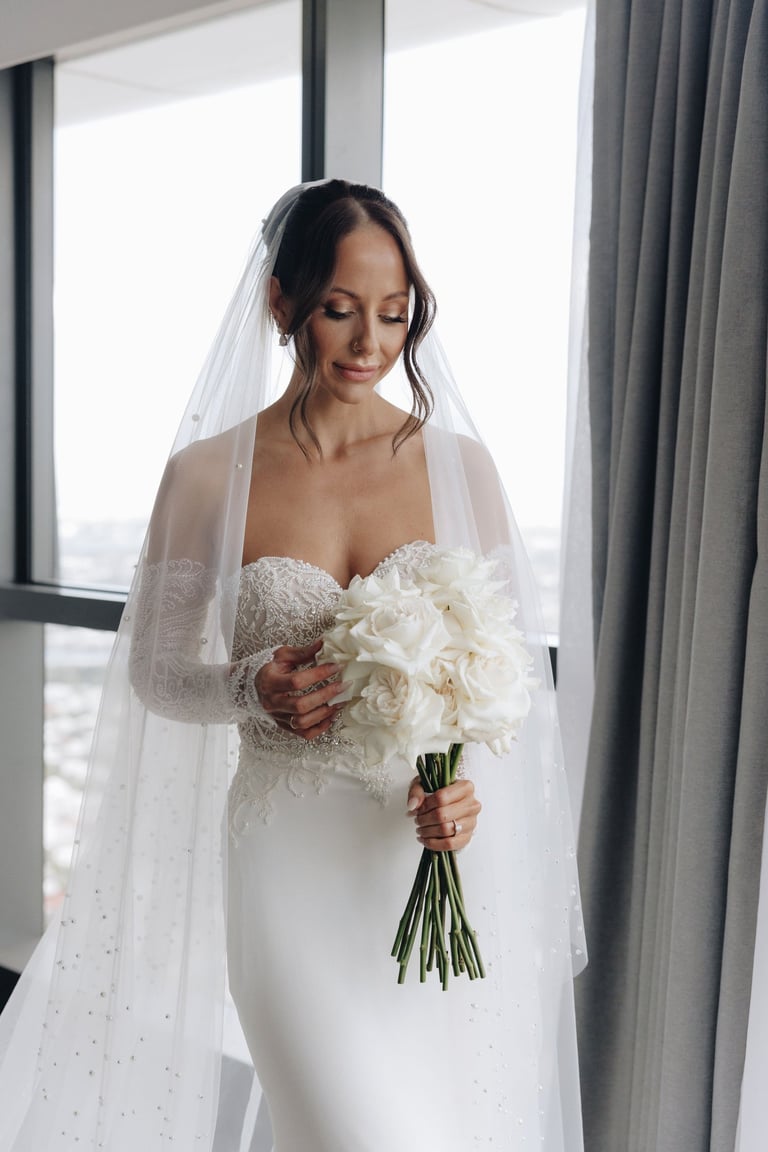 a bride in a white wedding dress with a veil
