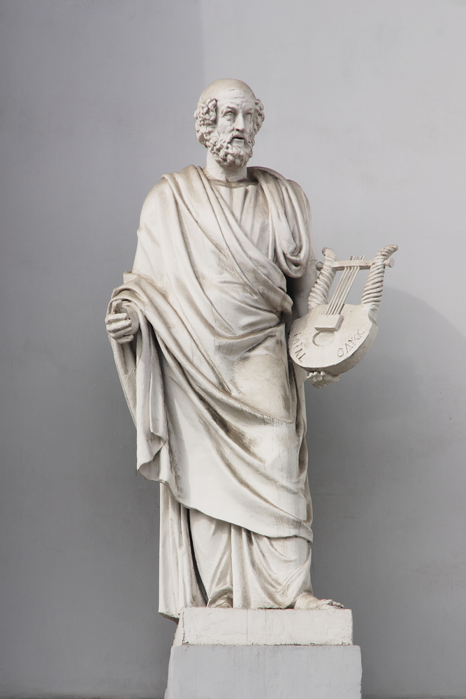 a statue of a man with a fan in his hand