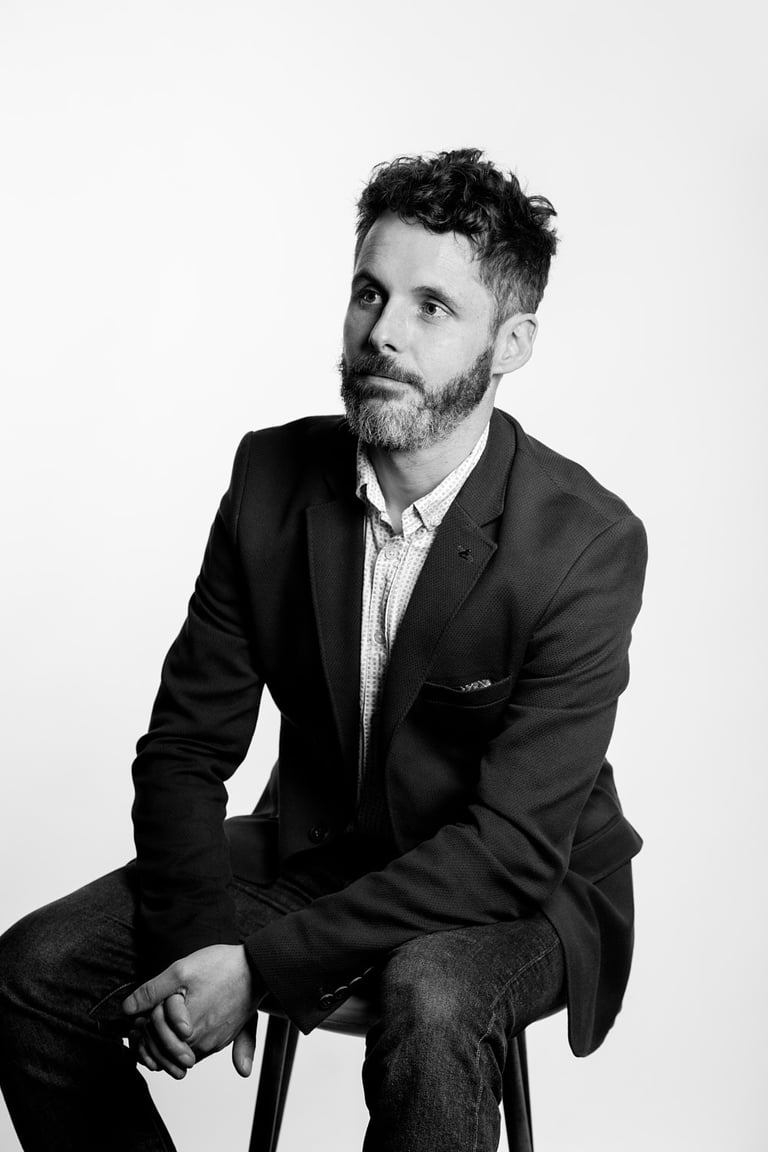 Schwarz-Weiß-Porträt eines Geschäftsmannes in einer Anzugsjacke.