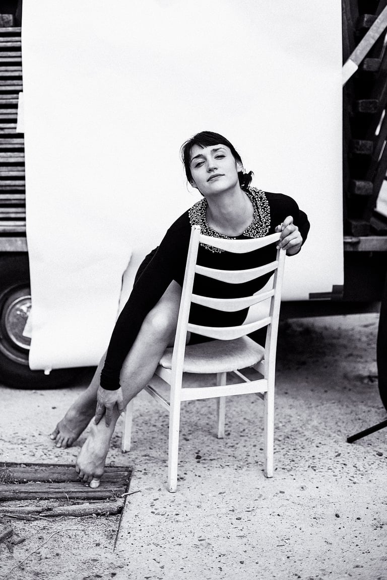 Actress Silvana Veit stretching  out on a chair.