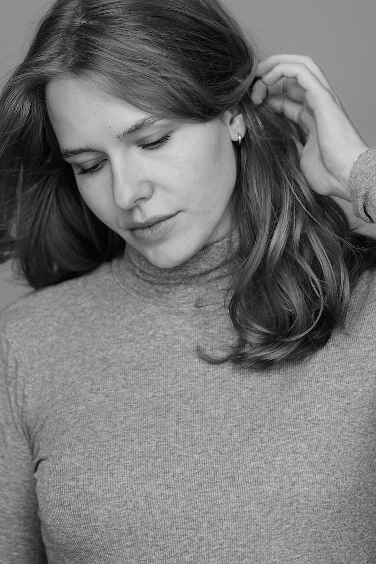 A black and white portrait of a woman in a studio.