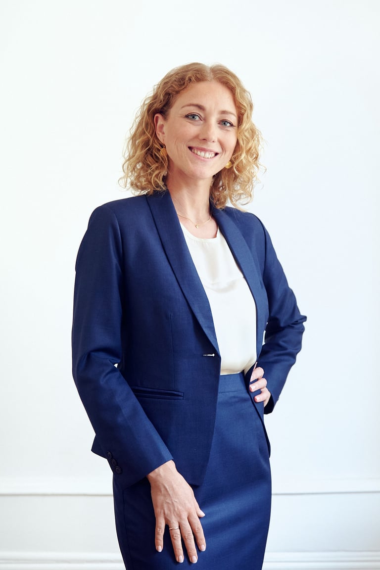 Eine blonde Geschäftsfrau in einem blauen Anzug.