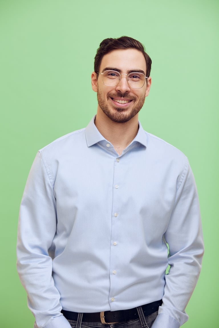 CV portrait of a young man with a green background.