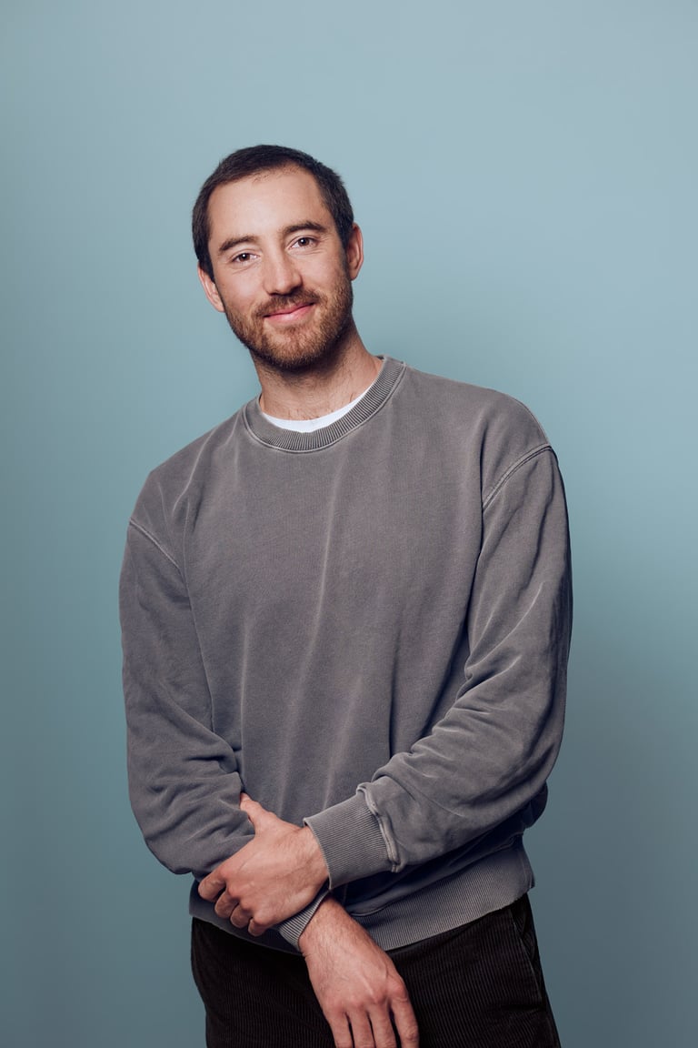 Portrait of a man with a blue background.