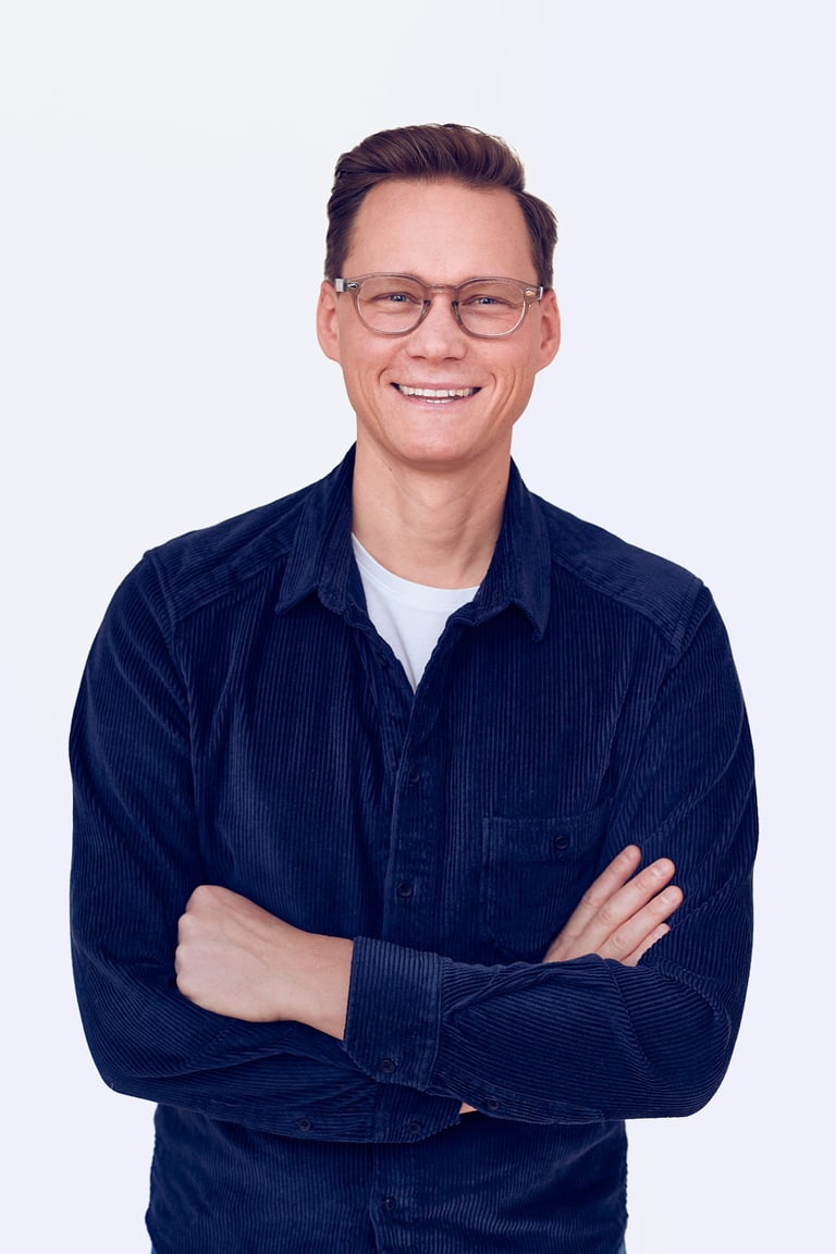 A happy man in a blue corduroy shirt.