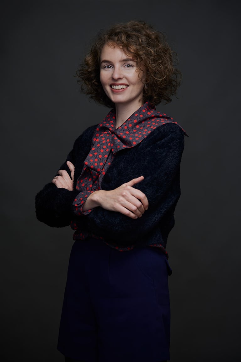 A studio portrait of a young woman.