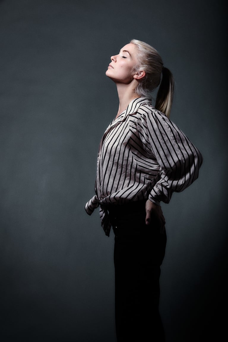 A woman with a ponytail breathing in.