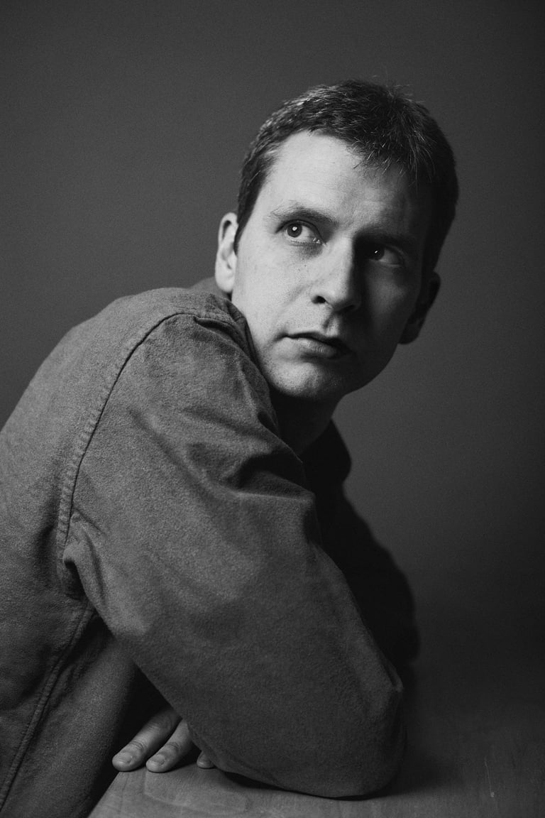 Portrait of writer Álvaro Del Olmo looking over his shoulder..