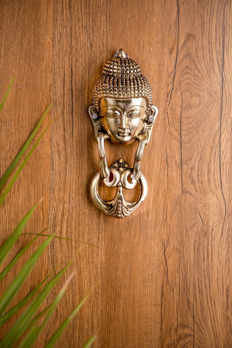 a door knocker with a buddha statue on it