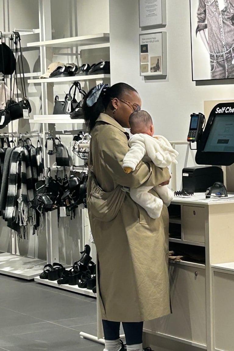 mum holding her baby in a shop