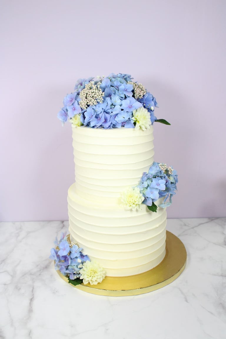 Tarta de boda elegante con flores naturales, diseño artesanal en Madrid