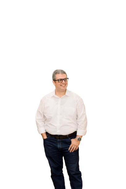 a man in a white shirt and jeans standing in front of a black background