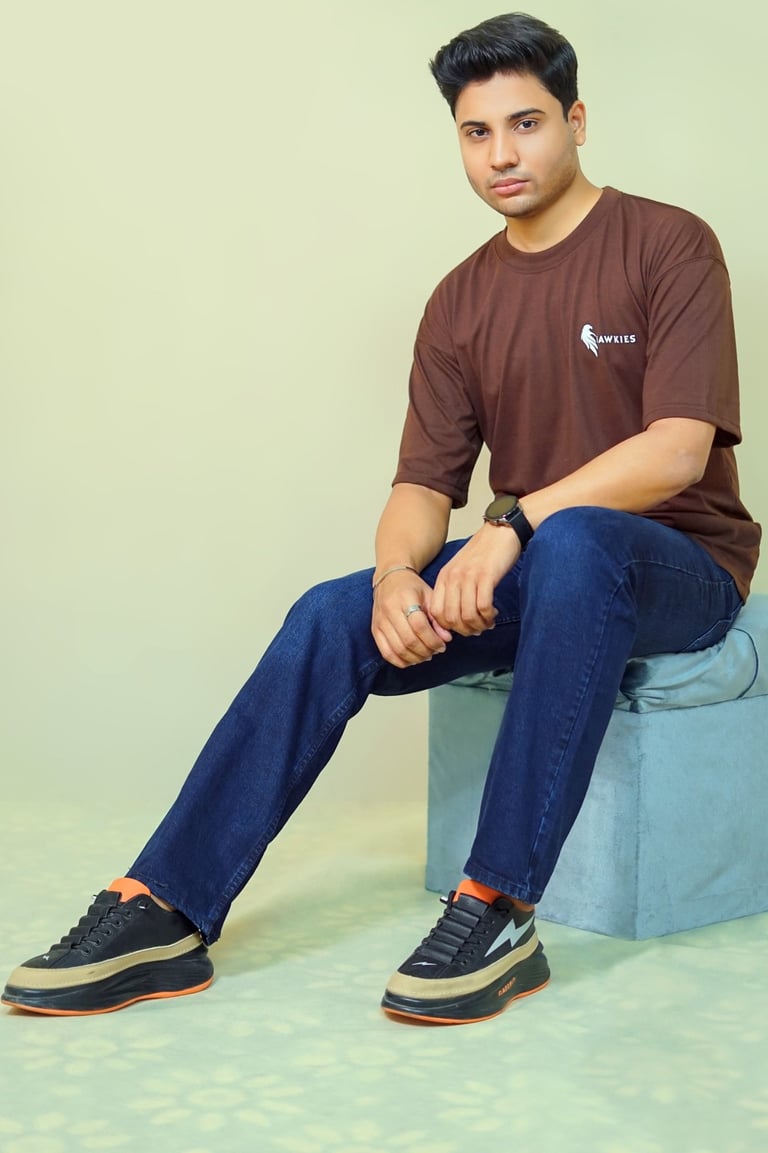 a man sitting on a blue stool with his feet on a stool